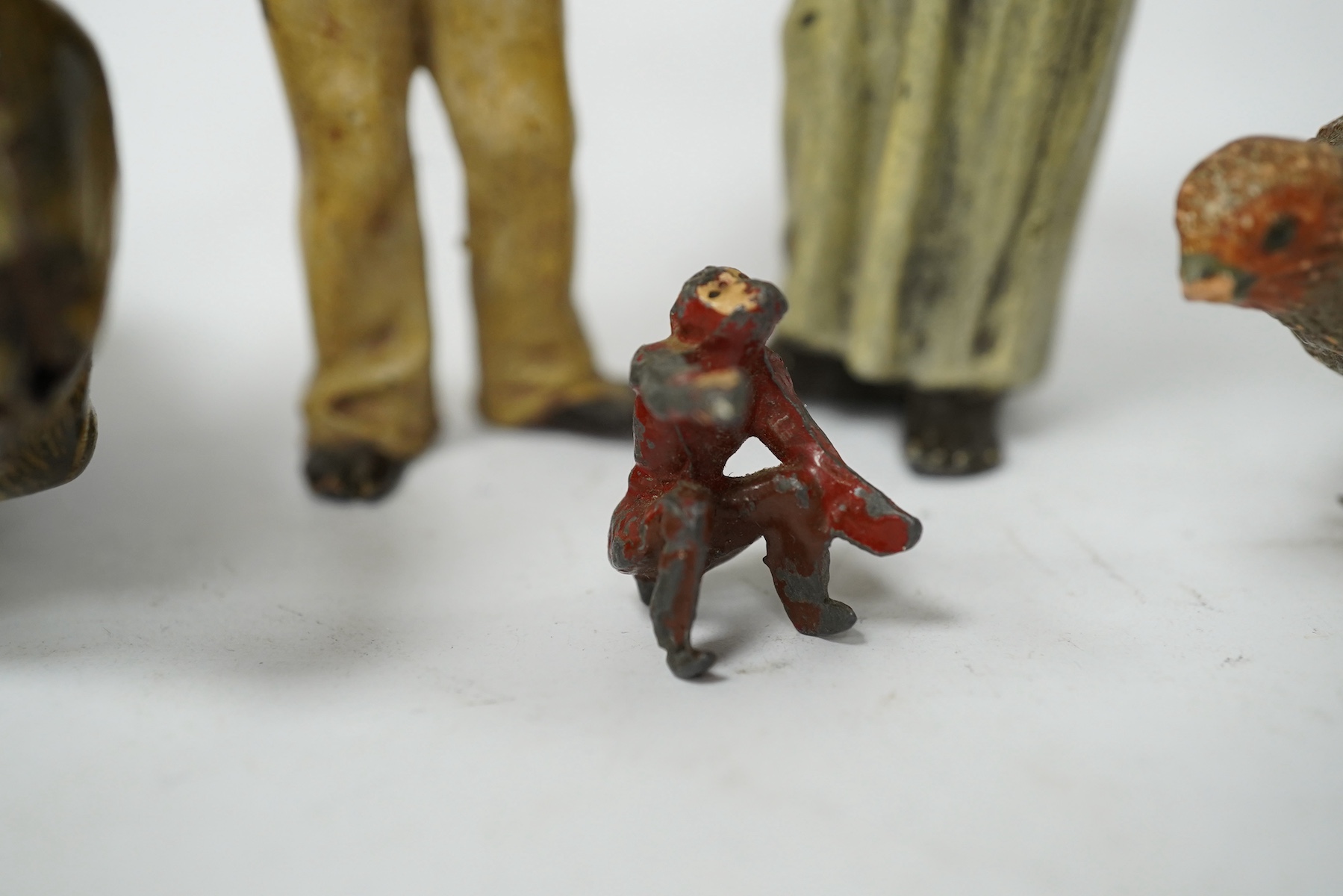 A collection of cold-painted figures and a tinplate and clockwork hare, largest 10cm high. Condition - fair